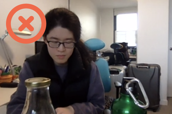 Student sitting exam. Unacceptable - objects within reach are not visible - either obscured or out of frame.