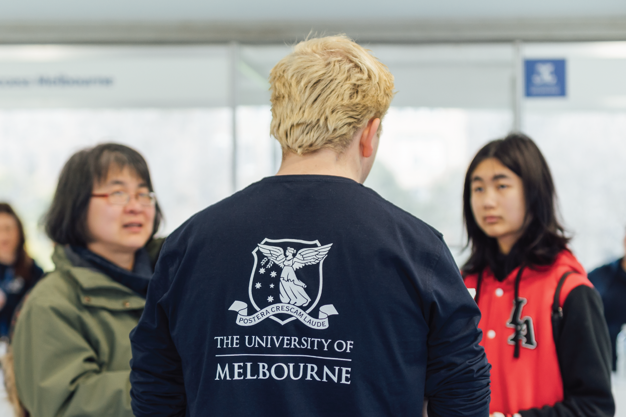 Students talking, one is wearing a Melbourne Uni hoodie