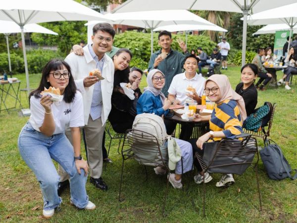 A group of students enjoying food on the lawn