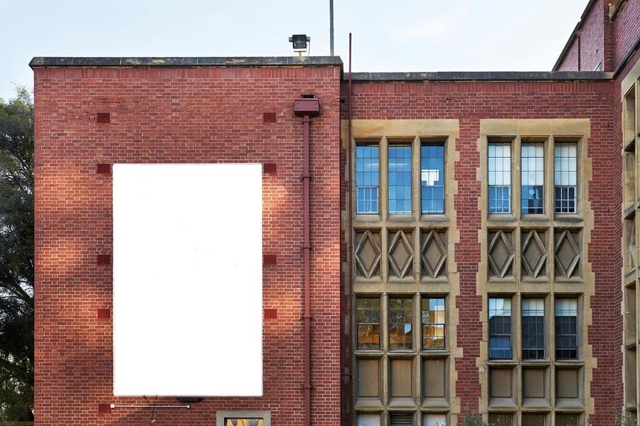 a brick wall at the University of Melbourne with a blank canvas mounting the wall. The canvas will be the site of the Art Prize