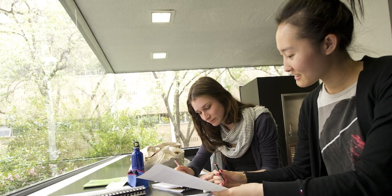 Two people looking over study materials