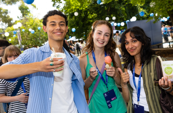 Students smiling in camera and eating ice cream 