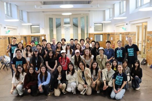 A group of university students and Student Peer Leader Network members pose together for a group photo