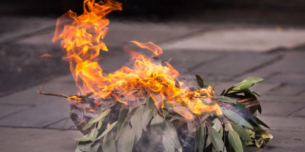 A small bundle of leaves burning ceremonially