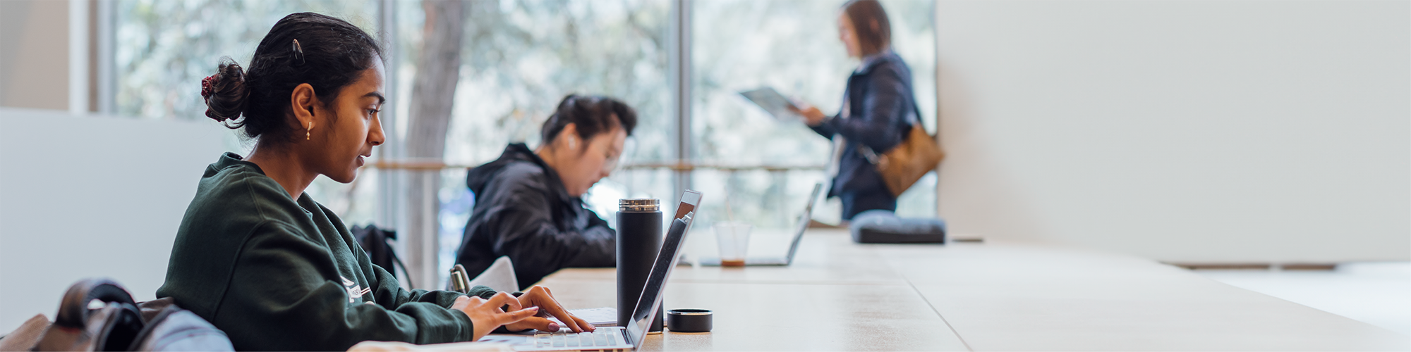 Student at desk working on laptop