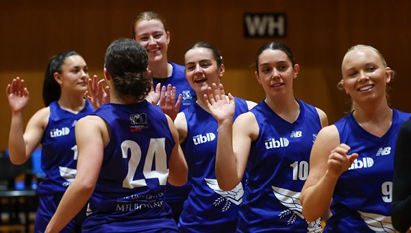 Members of the MU Sport netball team high-five each other after a game.