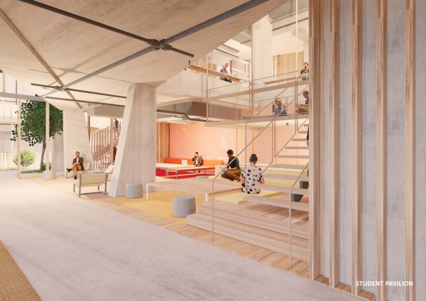 Study space within the Student Pavilion. Light timber runs up the stairwell and is mimicked on the floor. There are light orange couches in the corner of the space