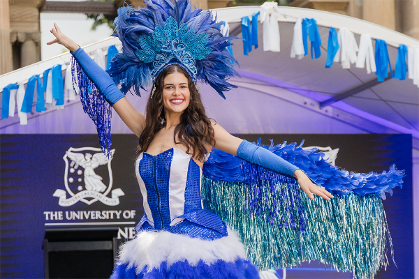 Dancer in blue feathered and sequined costume