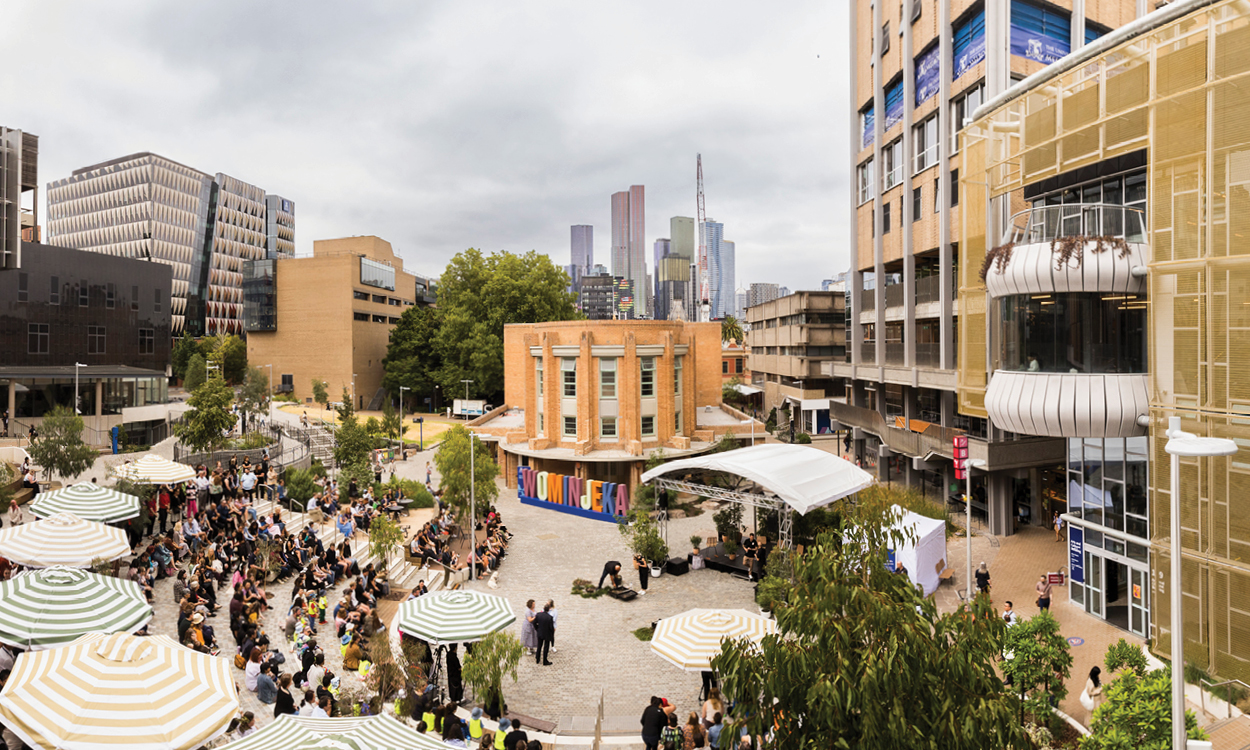 The student pavilion at the University of Melbourne, lively with students and striped umbrellas