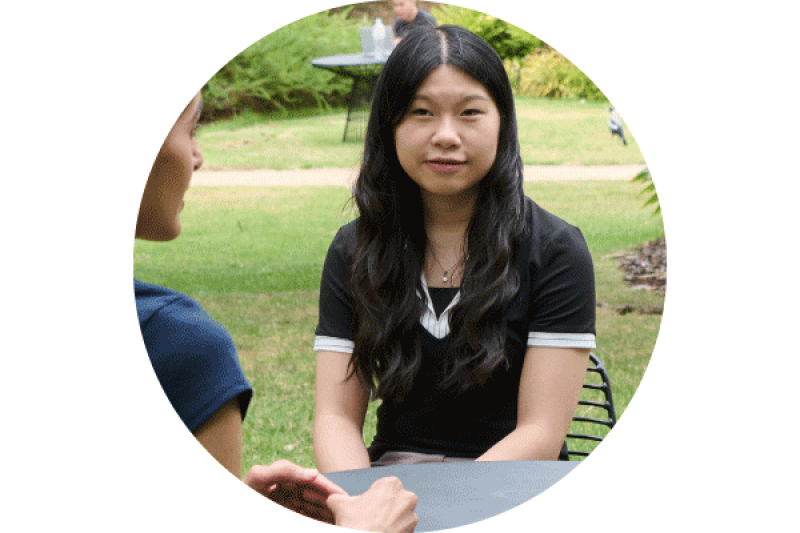 Catherine sitting outside with another student