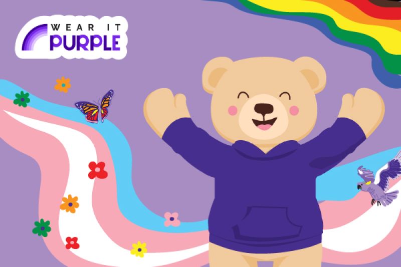 Graphic image of Barry the Bear wearing a purple jumper with pride colours in the background.