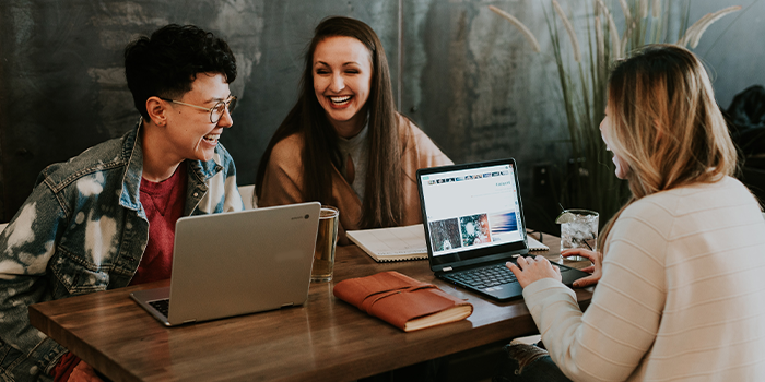 EmpWk2023_EventTiles_700x350px_MASTER_FILE_0003_brooke-cagle-g1Kr4Ozfoac-unsplash-copy.png Three students sitting around a table chatting and laughing with laptops