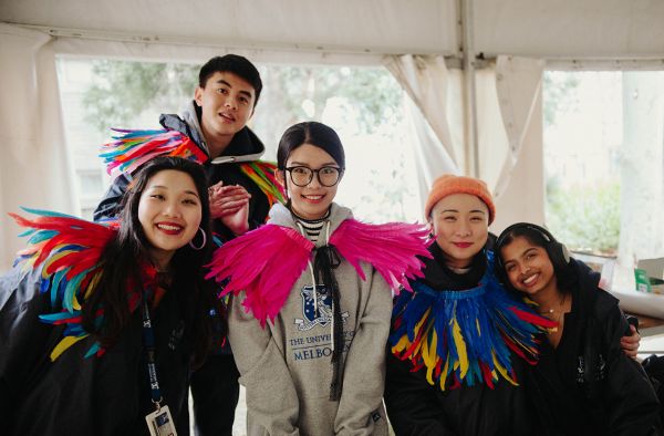 Group of students with colourful feather decorations