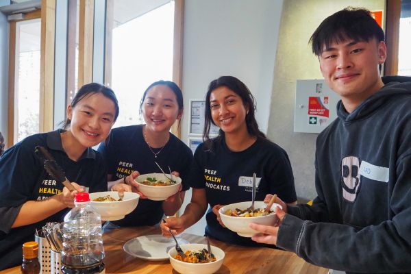Four Cooking Workshop students enjoying a meal together 