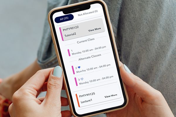 Image of person holding mobile phone and viewing a calendar.